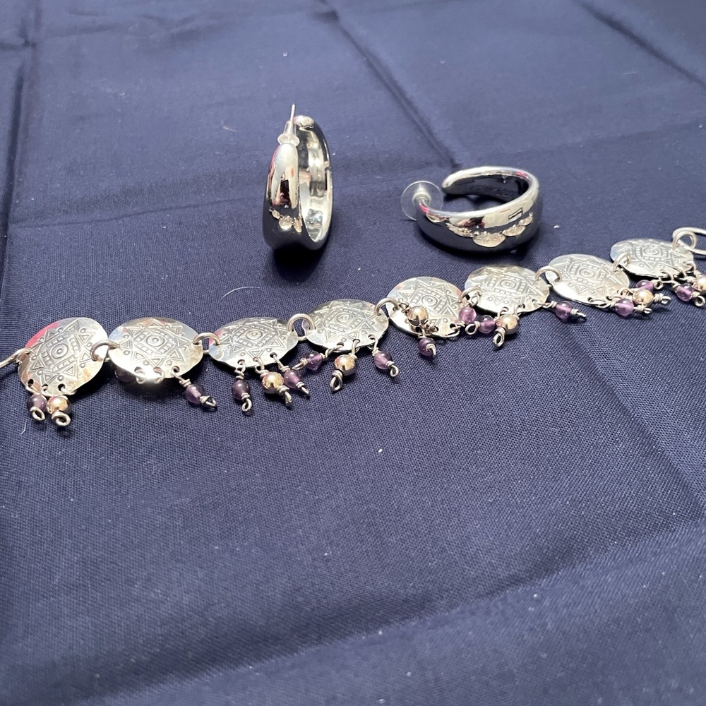 Hand made bracelet tooled silver circles with small dangling beads.